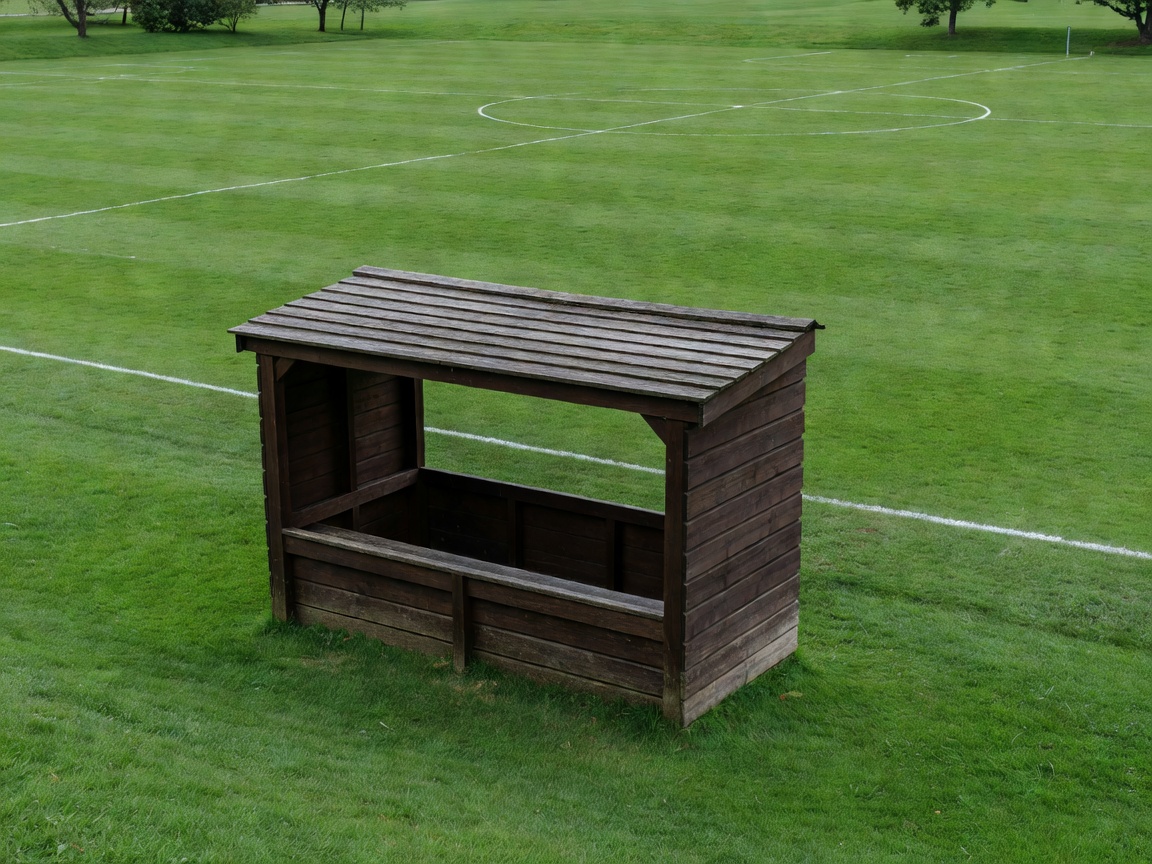 Wooden dugout beside a quiet community football ground
